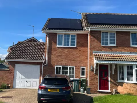 Outside of UK family home with panels on the roof